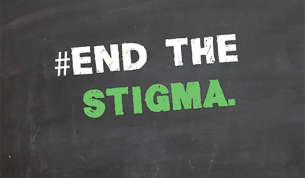 Chalkboard with #EndTheStigma message in white and green.
