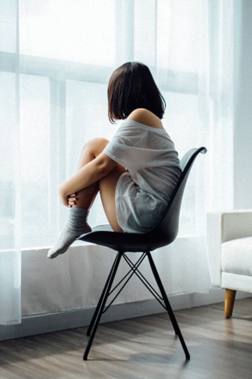 woman sitting by window