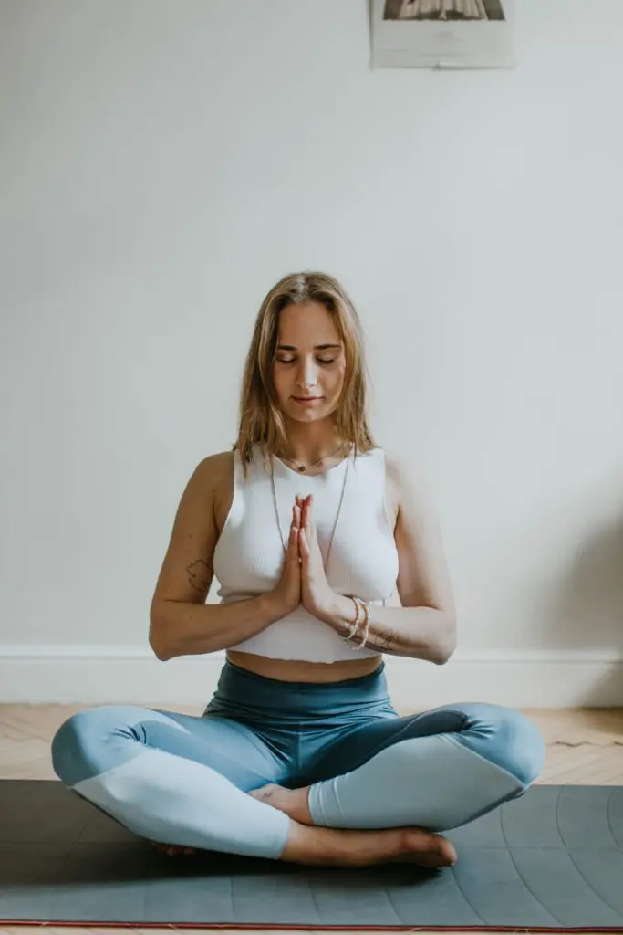Woman practicing yoga meditation for mental health and relaxation.