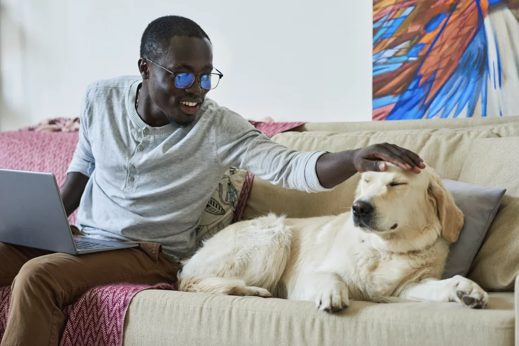 Happy man with dog on couch
