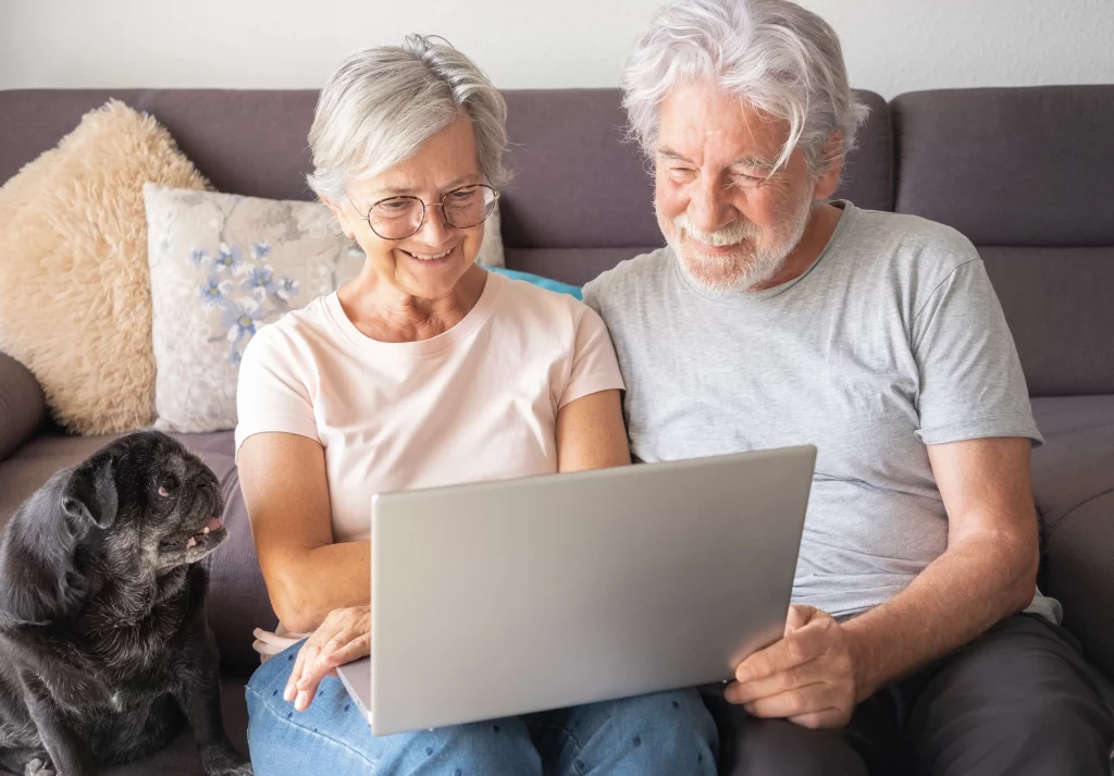 older couple looking at computer and smiling