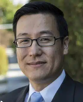Professional mental health expert in formal attire outdoors.