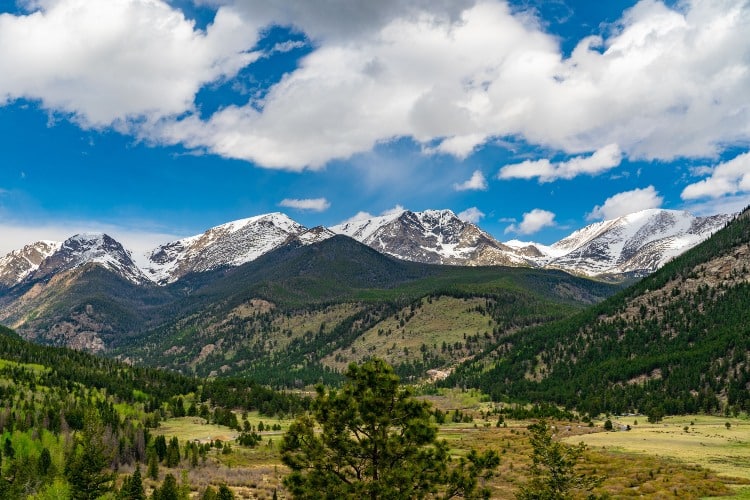 Shot of Rocky mountains in the national park with forests and sky in the background