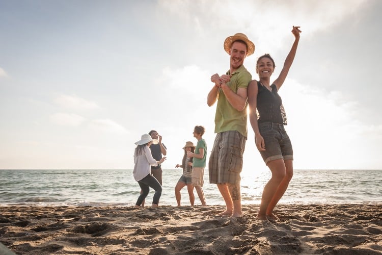 Multiracial group of friends having a party at beach.