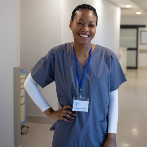 Portrait of happy african american female doctor in hospital corridor