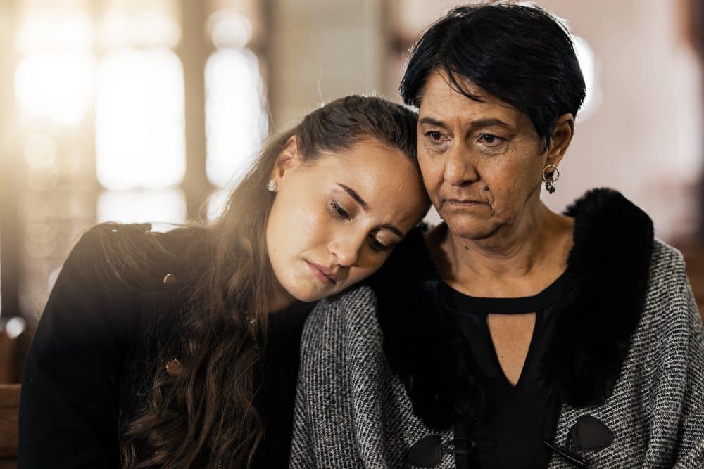 mother and daughter consoling eachother