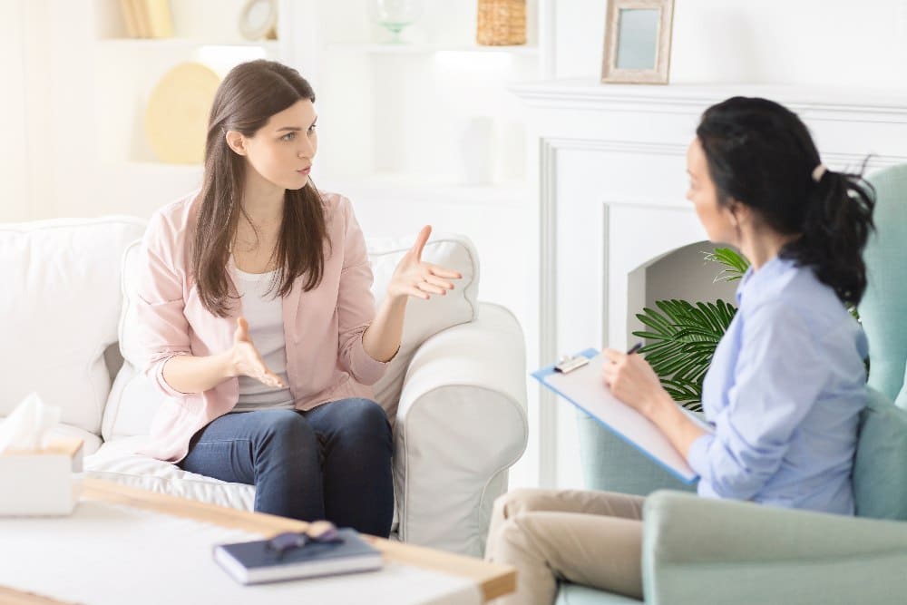 woman speaking to therapist