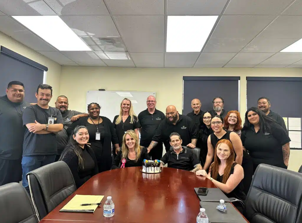 Group of diverse professionals celebrating at D'Amore Mental Health office.