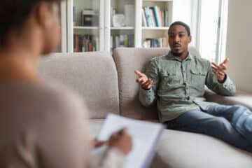 guy reclining on couch at therapist office,