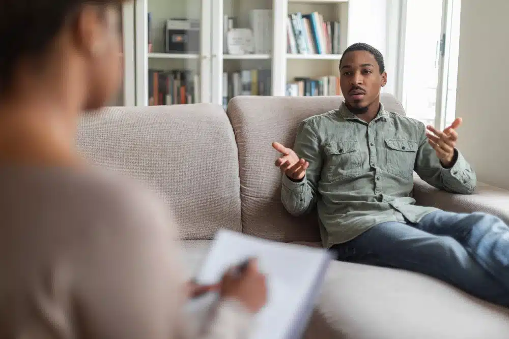 guy reclining on couch at therapist office,