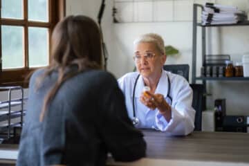 A woman asking a doctor when to seek inpatient treatment for anxiety.