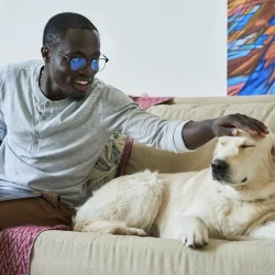 Happy man with dog on couch